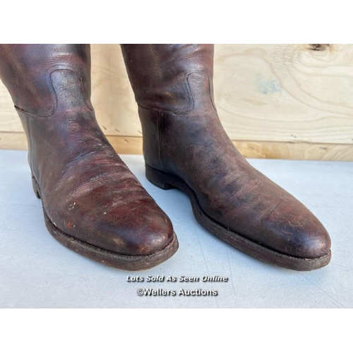 14 - A pair of brown leather riding boots, with wooden shoe trees from Thomas, 5 Saint James Street, Lond... 