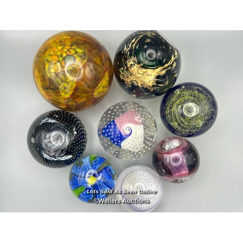 65 - Eight glass paperweights including Mdina and Eirian, largest 12cm high.