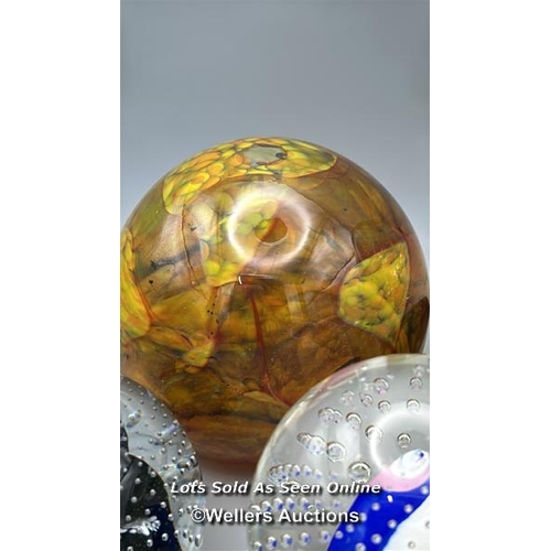 65 - Eight glass paperweights including Mdina and Eirian, largest 12cm high.