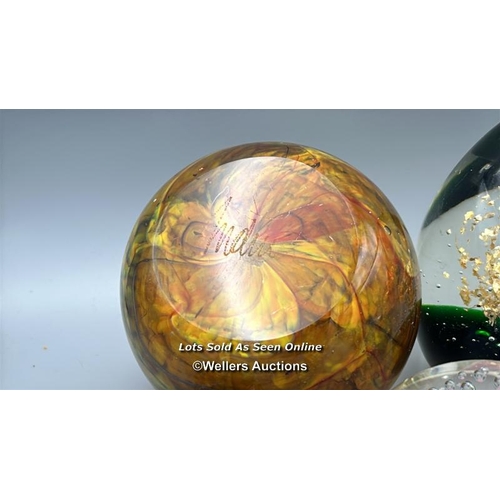 65 - Eight glass paperweights including Mdina and Eirian, largest 12cm high.