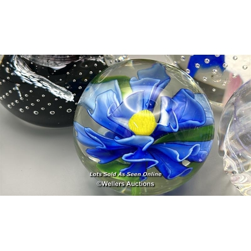 65 - Eight glass paperweights including Mdina and Eirian, largest 12cm high.