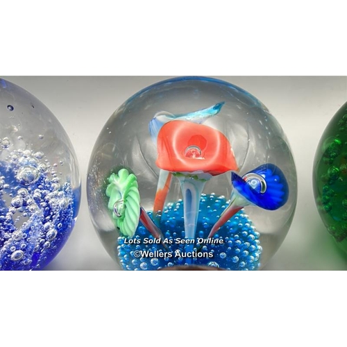 66 - Eight glass paperweights, largest 8cm high