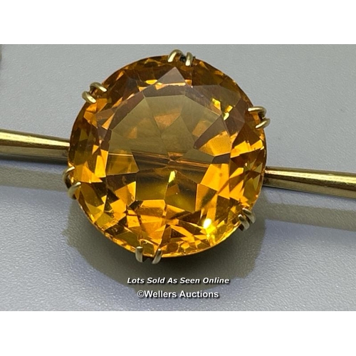 77 - Citrine bar brooch. Round citrine diameter 18.9mm, estimated weight 11.64ct, claw set on a tapering ... 