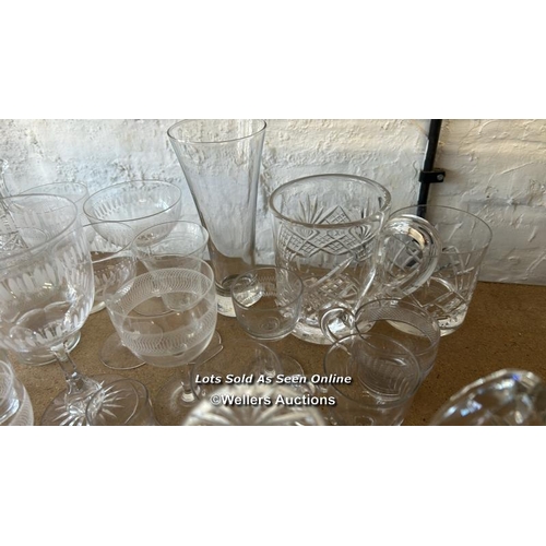 287 - A large collection of glassware including sherry glasses, wine glasses, bottles and perfume bottle /... 