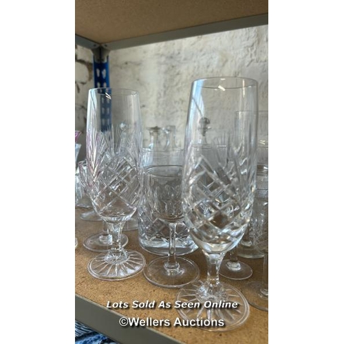 287 - A large collection of glassware including sherry glasses, wine glasses, bottles and perfume bottle /... 