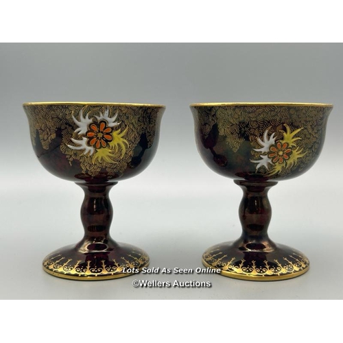 20 - A near pair of Carlton Ware goblets numbered 3889 with floral decoration and gilt interior, 8cm high... 