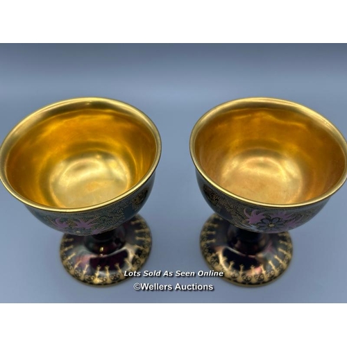 20 - A near pair of Carlton Ware goblets numbered 3889 with floral decoration and gilt interior, 8cm high... 