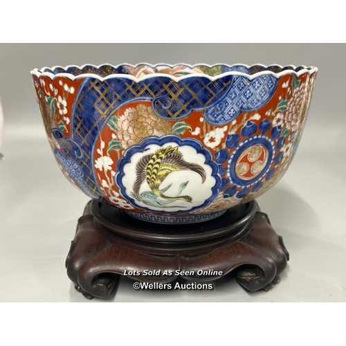 8 - A large Japanese bowl with scalloped rim, heavily decorated with birds, flowers and gilt detail on c... 