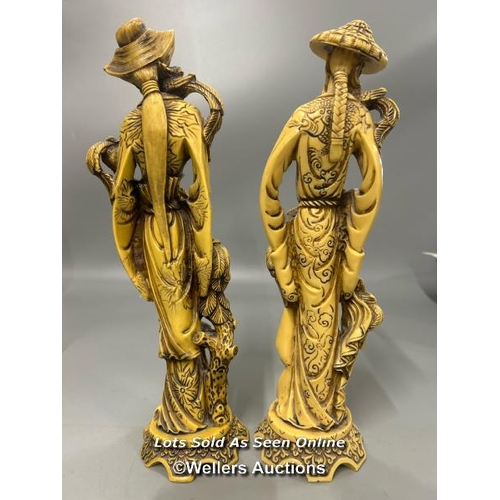 37 - A pair of resin figurines of a Japanese man and women, 36 cm high / AN7