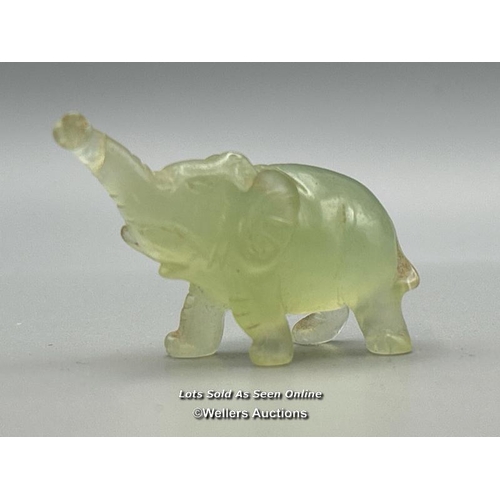 40 - A small carved jade figure of an Elephant on wooden base, 3cm high, 23.5g in fitted box (Lot subject... 