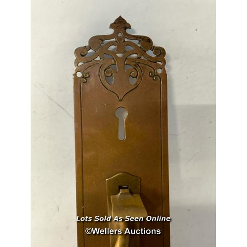 301 - Brass pull door handle on ornately shaped back panel with key hole and lever