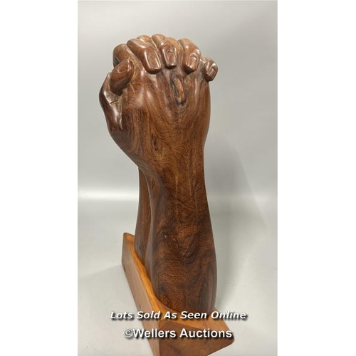 95 - Large carved wooden sculpture of praying hands on a seperate wooden base, 46cm high, base 24.5cm wid... 