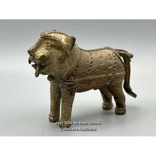 149 - Four brass dhokra cast animals including three Tigers and a Cow, tallest, 7cm high / AN48