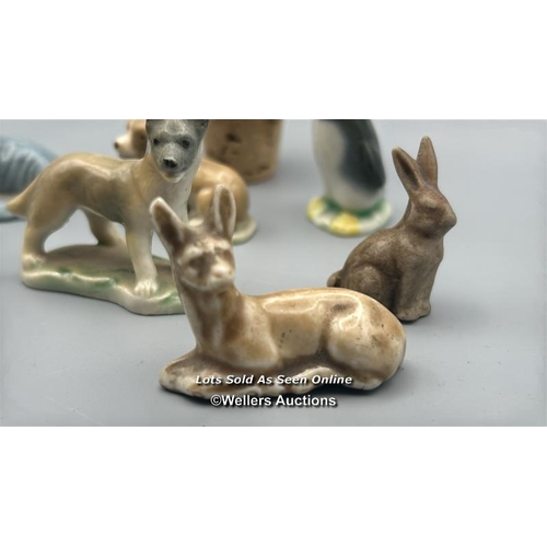 160 - Miniature animal figurines including ceramic Dogs, Seal, Penguin and Deer, with a white carved stone... 