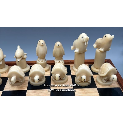 161 - A chess set made in the Galapagos Islands, chess pieces carved from Tagua nut in the form of Seals, ... 