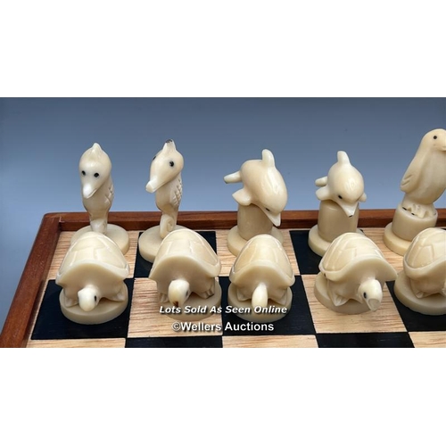 161 - A chess set made in the Galapagos Islands, chess pieces carved from Tagua nut in the form of Seals, ... 