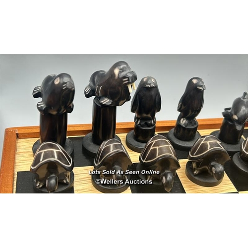 161 - A chess set made in the Galapagos Islands, chess pieces carved from Tagua nut in the form of Seals, ... 