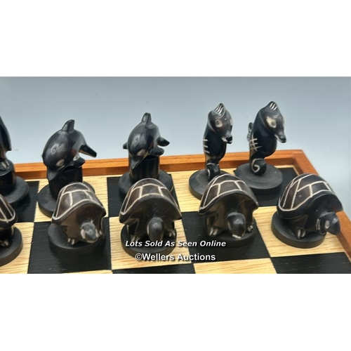 161 - A chess set made in the Galapagos Islands, chess pieces carved from Tagua nut in the form of Seals, ... 