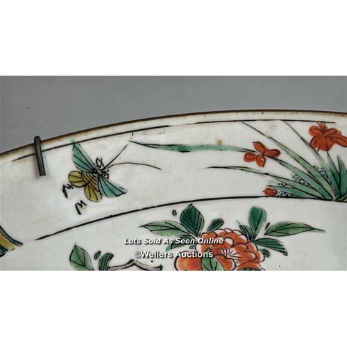 172 - A Chinese famille verte porcelain charger decorated with two long tailed birds, one in flight and th... 