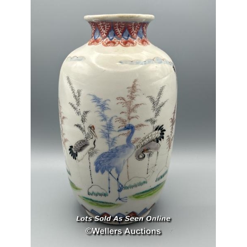 174 - A near pair of oriental porcelain famille verte vases decorated with Cranes one larger than the othe... 