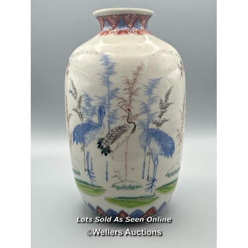 174 - A near pair of oriental porcelain famille verte vases decorated with Cranes one larger than the othe... 