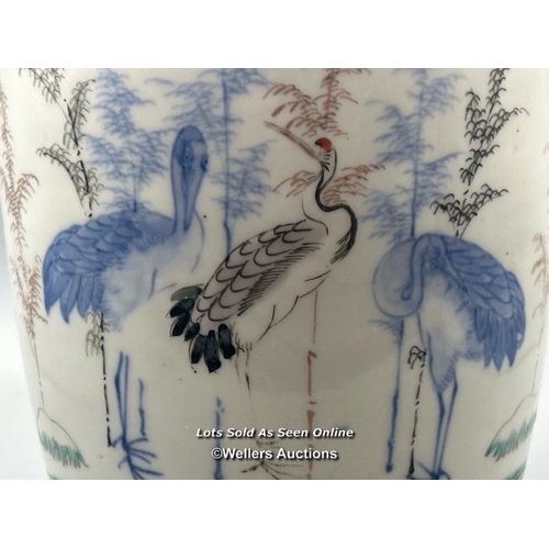 174 - A near pair of oriental porcelain famille verte vases decorated with Cranes one larger than the othe... 