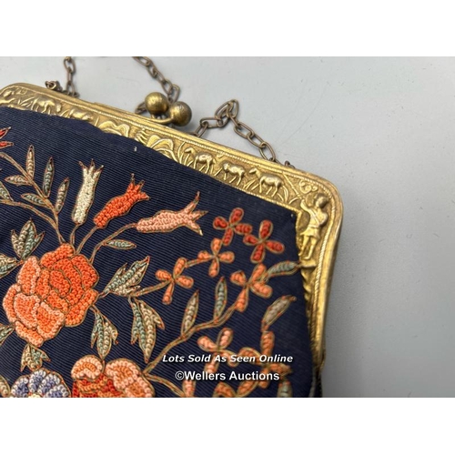 182 - Two vintage evening purses, one with embroidered flowers and metal clasp decorated with farmers and ... 