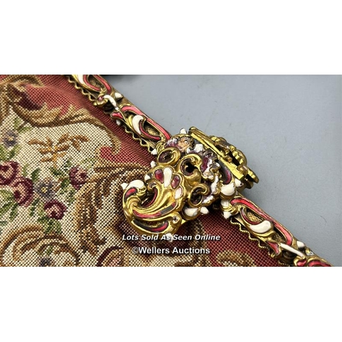 184 - A vintage embroidered evening purse with ornate yellow metal clasp and handle decorated with red and... 