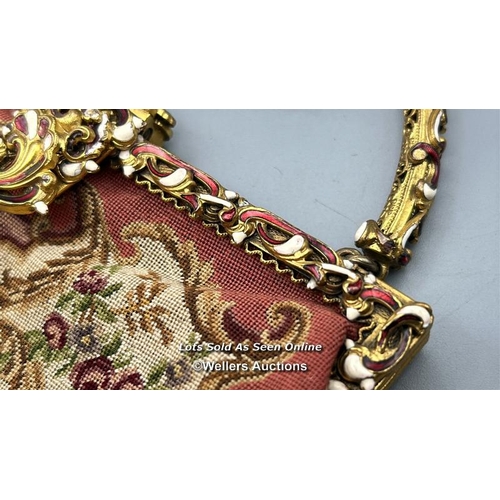 184 - A vintage embroidered evening purse with ornate yellow metal clasp and handle decorated with red and... 