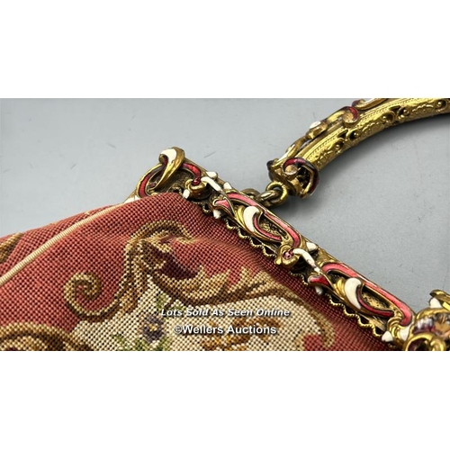 184 - A vintage embroidered evening purse with ornate yellow metal clasp and handle decorated with red and... 