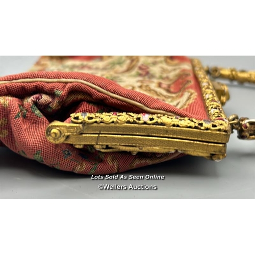 184 - A vintage embroidered evening purse with ornate yellow metal clasp and handle decorated with red and... 