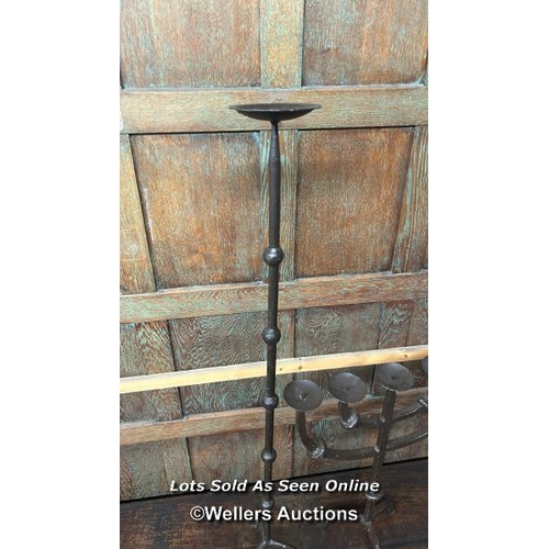 282 - Two cast iron candle holders, largest 108 cm high