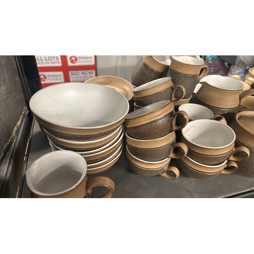 1 - A large collection of Denby 'Cotswold' stoneware tableware including tea cups, coffee cups, soup bow... 