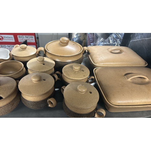 1 - A large collection of Denby 'Cotswold' stoneware tableware including tea cups, coffee cups, soup bow... 