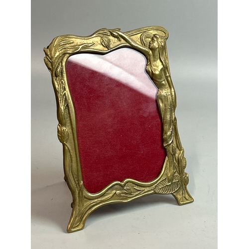 26 - A small brass art nouveau style picture frame, (10.5 x 13cm), a red leaf shaped bowl stamped Laure J... 