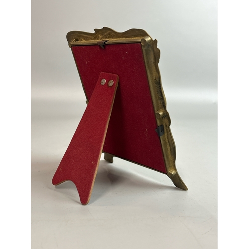 26 - A small brass art nouveau style picture frame, (10.5 x 13cm), a red leaf shaped bowl stamped Laure J... 