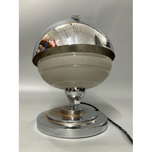 27 - Art deco chrome effect and frosted glass globe shaped table lamp, 32cm high, in working order with a... 