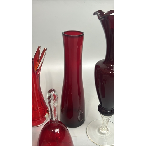 43 - Assorted red / cranberry glassware including vases, candle holder, bell and bottles / AN8