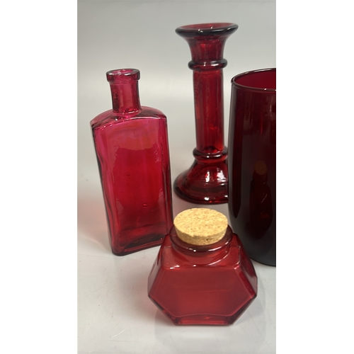 43 - Assorted red / cranberry glassware including vases, candle holder, bell and bottles / AN8