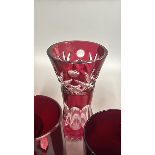 43 - Assorted red / cranberry glassware including vases, candle holder, bell and bottles / AN8