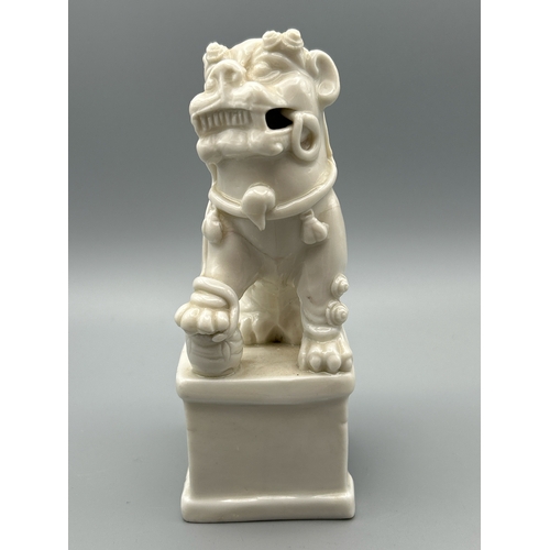 51 - A Chinese Kangxi period Blanc de Chine Dog of Fu or Buddhistic Lion joss stick holder, 13cm high / A... 