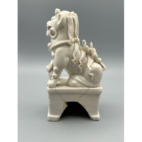 51 - A Chinese Kangxi period Blanc de Chine Dog of Fu or Buddhistic Lion joss stick holder, 13cm high / A... 