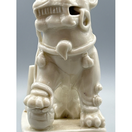 51 - A Chinese Kangxi period Blanc de Chine Dog of Fu or Buddhistic Lion joss stick holder, 13cm high / A... 