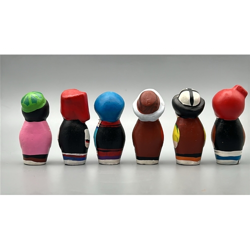 61 - Six small hand painted clay dolls, all around 5cm high / AN17