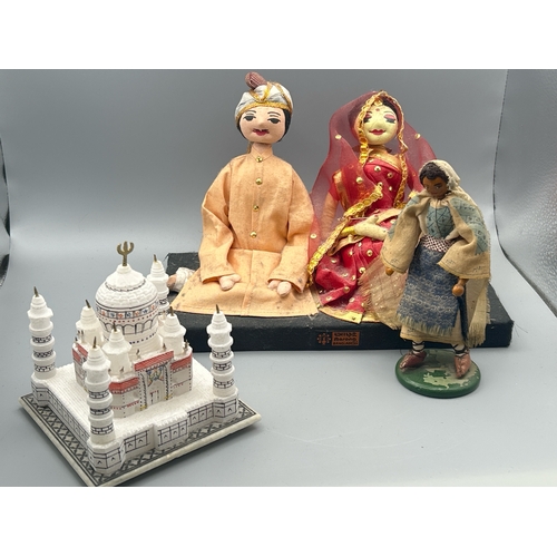 63 - A pair Bangladeshi wedding dolls, 17cm high, a small wooden doll on green stand, 14cm high and a box... 