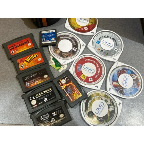 42 - Tin containing a Sony PSP and games, untested / Container number:BM000098