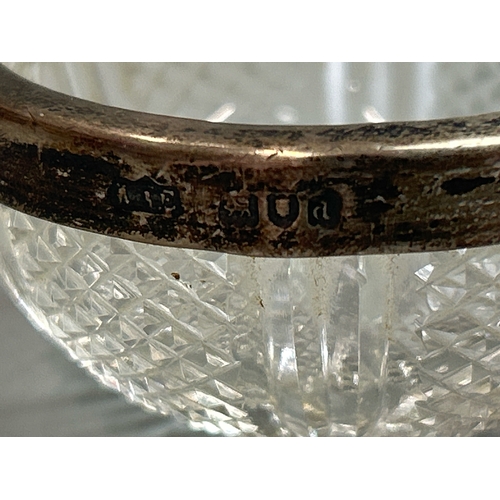 25 - A hallmarked silver topped vinegar bottle, and silver rimmed pot with a three glass dishes and glass... 