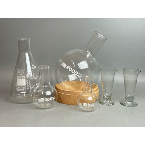 28 - Six glass laboratory flasks including a Glassco 2000ml bottle with stand / T13