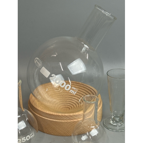 28 - Six glass laboratory flasks including a Glassco 2000ml bottle with stand / T13