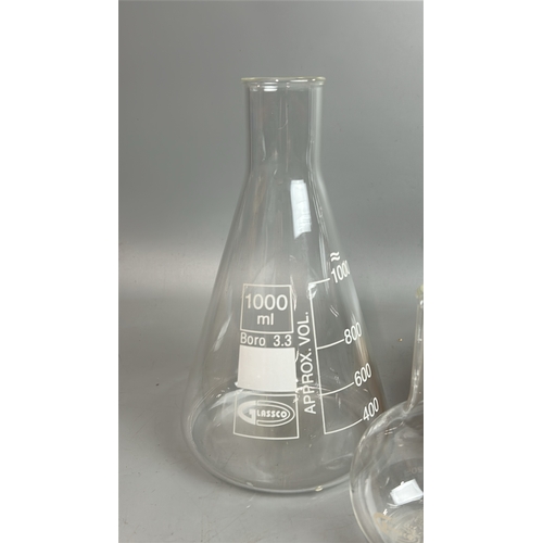 28 - Six glass laboratory flasks including a Glassco 2000ml bottle with stand / T13